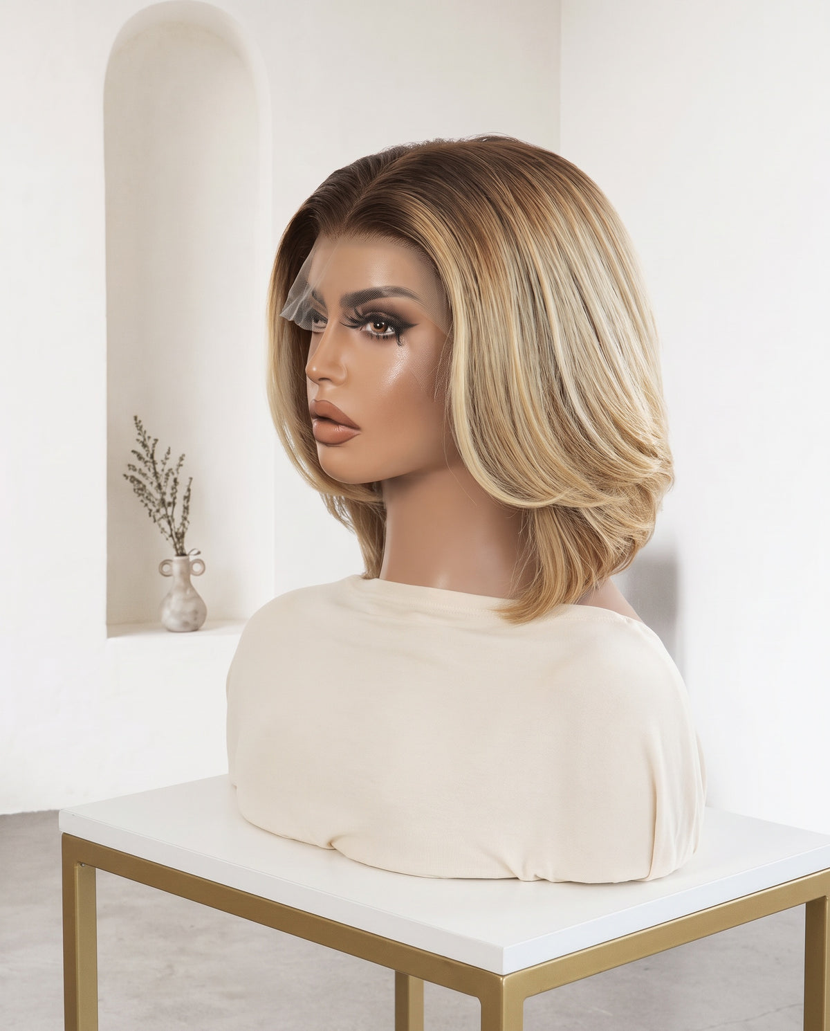 Giselle rooted blonde bob wig on a display stand