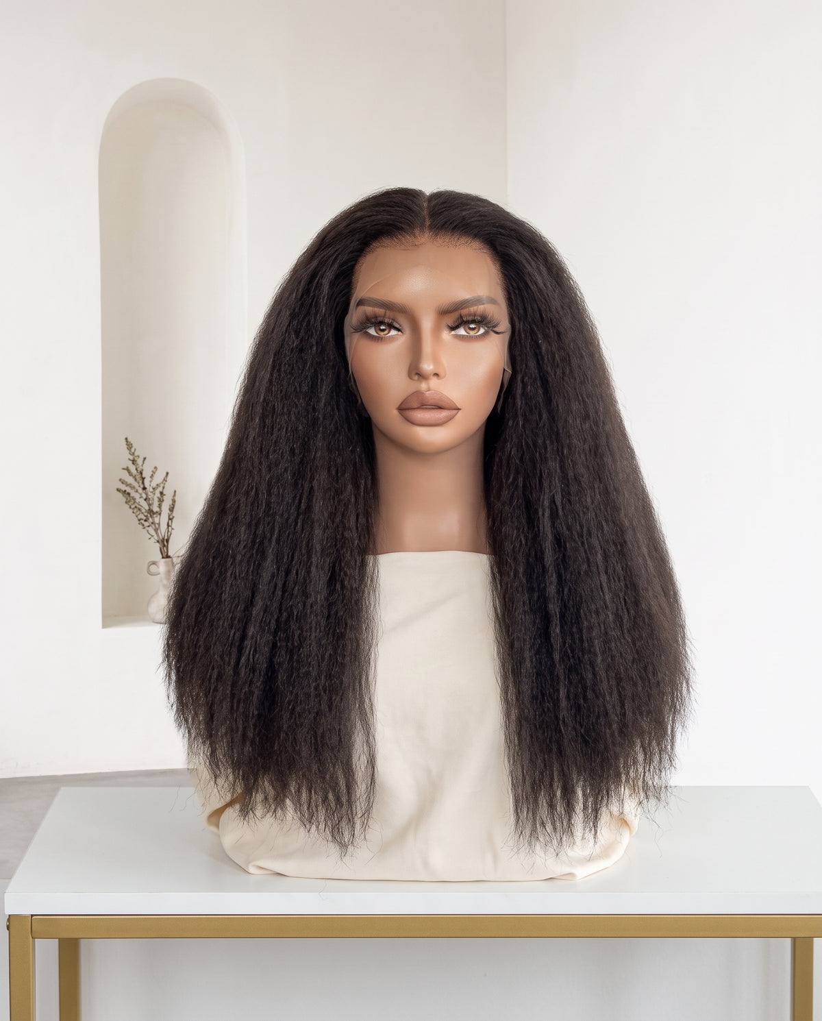 Imani natural black kinky straight wig on a display stand